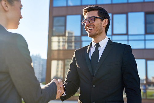 Successful business partners handshaking after negotiation