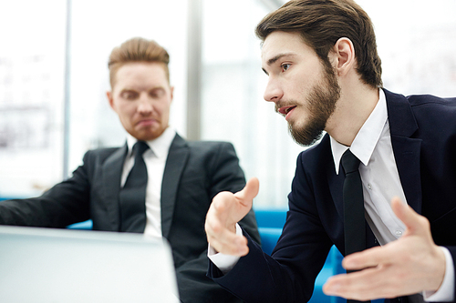 Salesman explaining his idea of overcoming crisis to co-worker