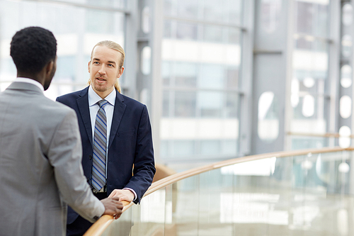 Contemporary co-workers having discussion in office center