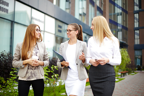 Female employees discussing working day while coming back home