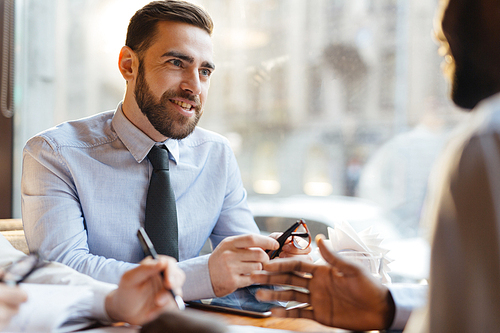 Confident employer talking to candidate for vacancy