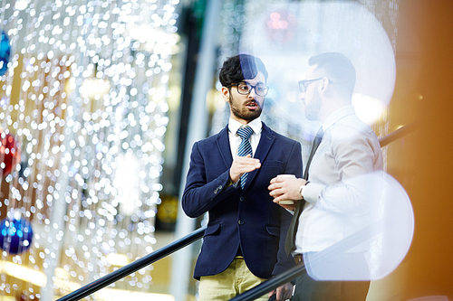 Hispanic businessman communicating to his colleague