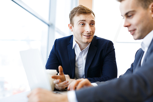 Young trader making presentation of new project to colleague