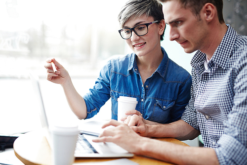 Co-working traders discussing sales information online