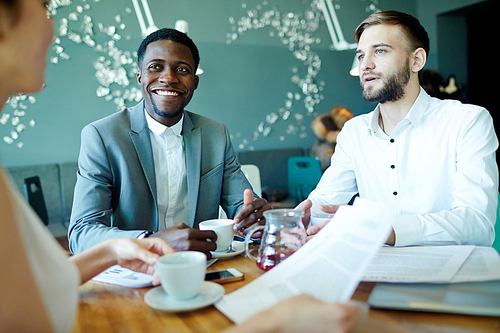 Successful employers talking to manager at briefing