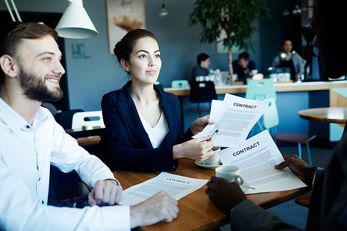 Confident lawyers consulting businessman about terms of contract