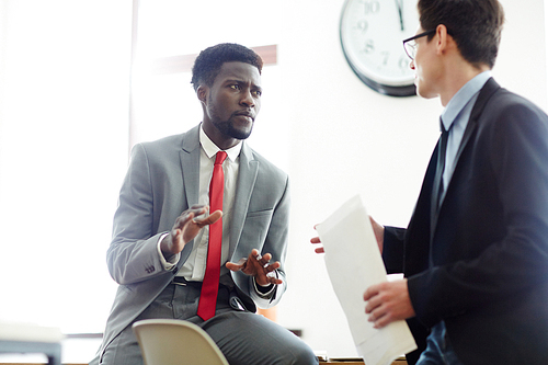 Confident business partners having talk at meeting