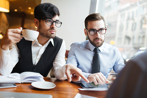 Confident employees having discussion with business partner