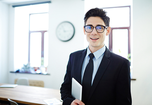 Elegant financial expert with tablet  in office