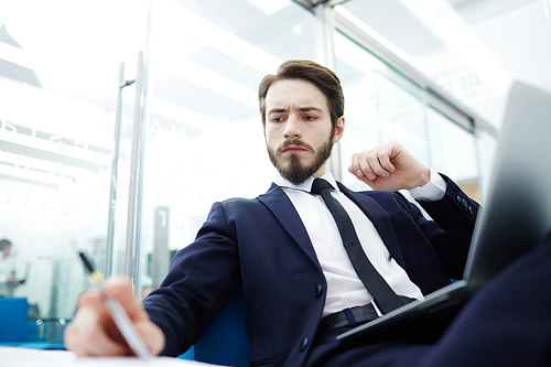 Busy salesman reading financial papers