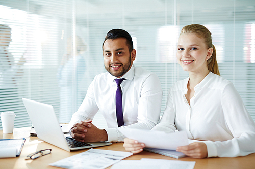 Young man and woman in formalwear  while working