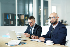 Serious businessman and his colleague planning work