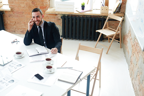 Successful leader consulting employee on telephone