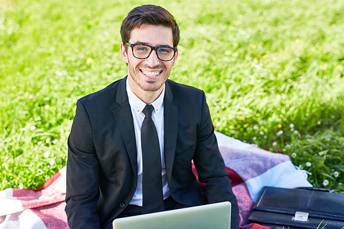 modern businessman networking on green lawn in natural