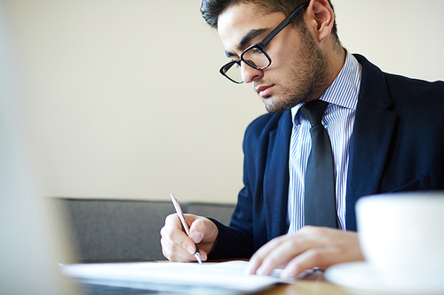 Man in formalwear signing papers