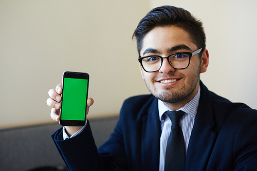 Successful businessman showing curious issue or advert in his smartphone