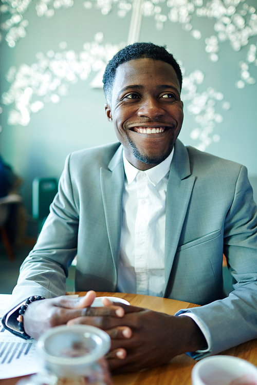 Successful young employer sitting in cafe