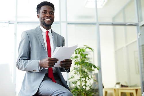 Contemporary young banker in suit working in office