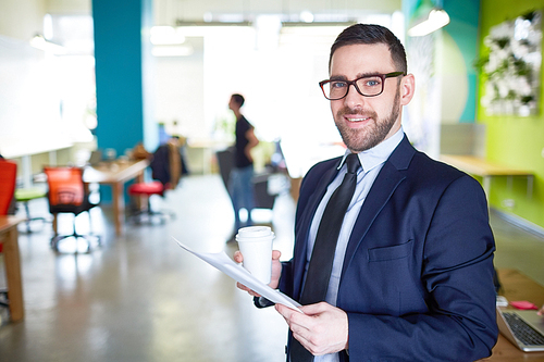 Business leader with paper and drink 