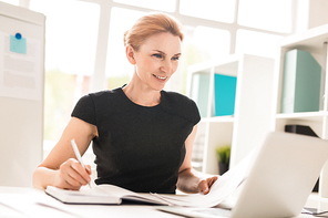 Confident financial manager or broker working in front of laptop