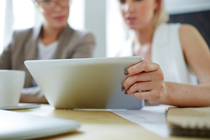 One of colleagues making online presentation or showing data to co-worker