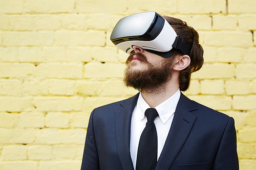 Y generation businessman with headset enjoying virtual reality