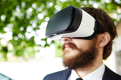 Bearded man with vr goggles in natural environment