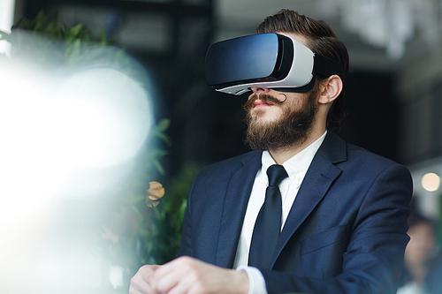 Business professional with vr goggles watching video