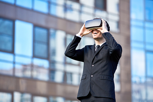 Contemporary businessman enjoying virtual reality experience