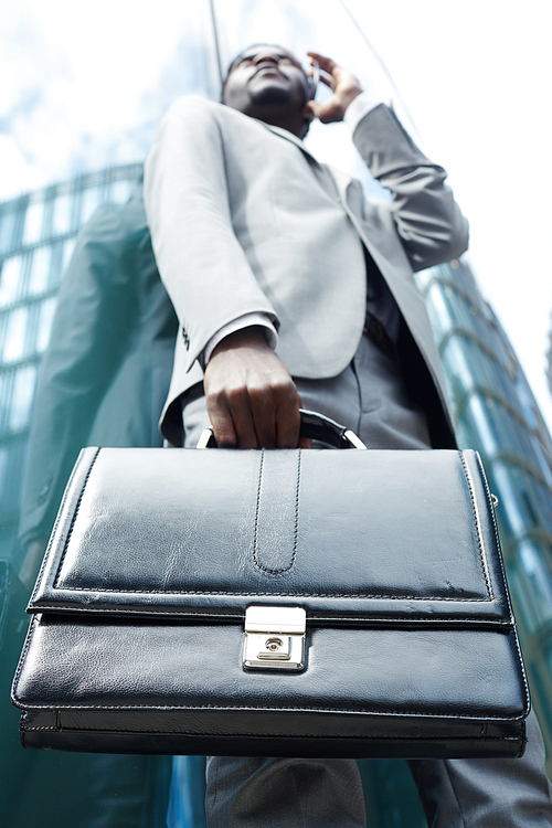 Leather briefcase in hand of modern salesman