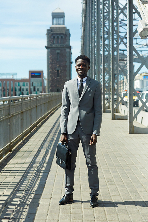Businessman in suit standing by urban road