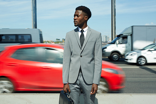 Young agent standing by highway