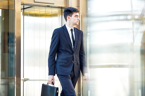 Serious banker with briefcase going to work