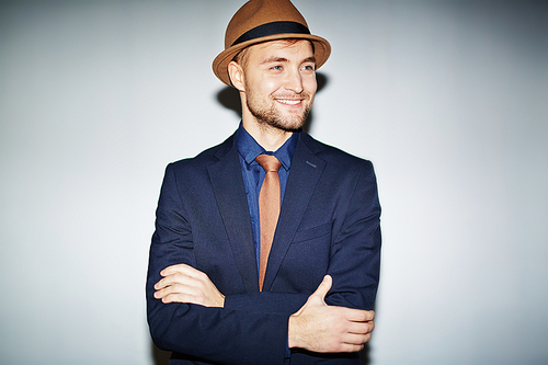 Stylish guy in suit, tie and hat