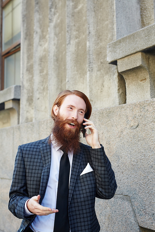 Mobile businessman consulting one of clients by phone