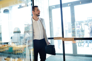 Businessman opening door of cafeteria during lunch break