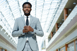 Contemporary young businessman wearing grey suit