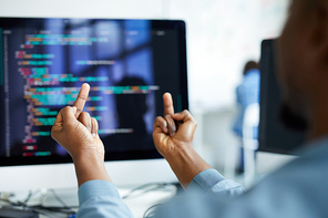 Close-up of unrecognizable African man flipping desktop computer with error off and showing fuck off gestures