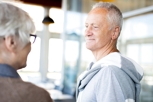 Portrait of modern senior man looking at his wife with love and affection smiling happily, copy space