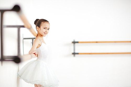 Happy girl in ballet dress  with smile during training in class