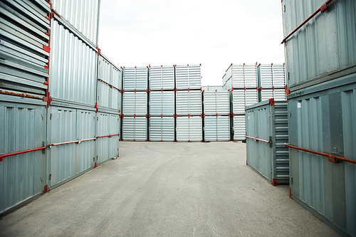 Abundance of sealed metal cargo containers stacking outdoors, shipping storage