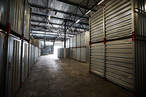 Dark cargo storage room with metal roof where stacking containers
