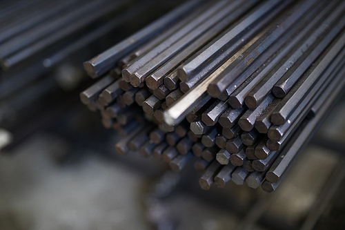 Close-up of stack of metal pipes on the shelf