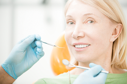 Mature blond woman  before dental check-up during visit to dentist
