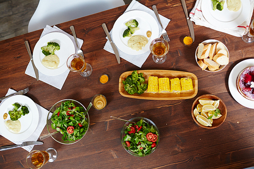 Overview of homemade meals and drinks sesrved on wooden table