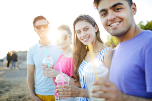 Two happy young couples  while enjoying sunny day on beach