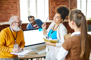 Group of casual colleagues discussing working moments or organization points at meeting