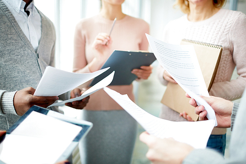 Human hands with financial documents during business meeting of economists