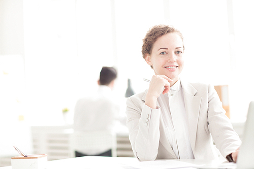 Portrait of businesswoman sitting at the table and smiling