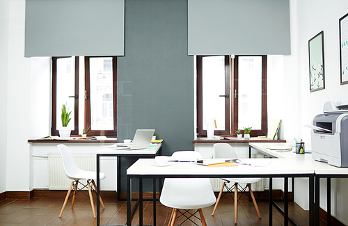 Interior of modern spacious open plan office without people, lit by natural light